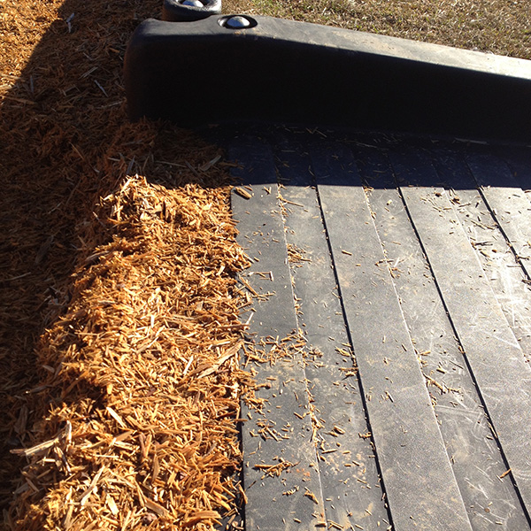 Rubber transition mat providing wheelchair access from the border to the playground mulch.