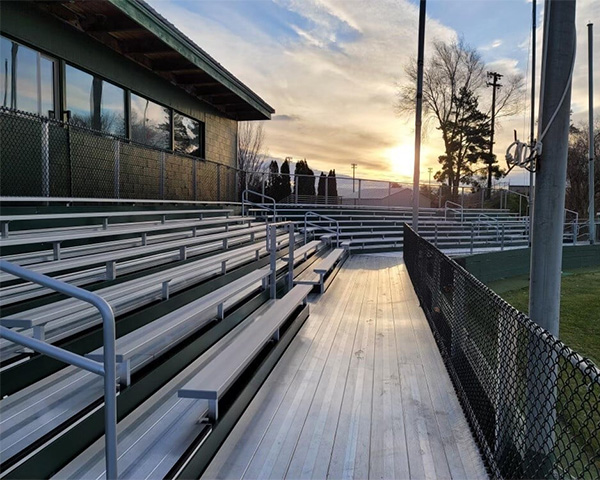 SR Carolinas aluminum sports bleachers by baseball field at sunset in The Carolinas