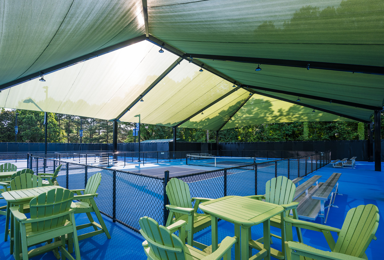 Green canopy shade covering pickleball spectator seating at Burlington Pickleball Complex in North Carolina.