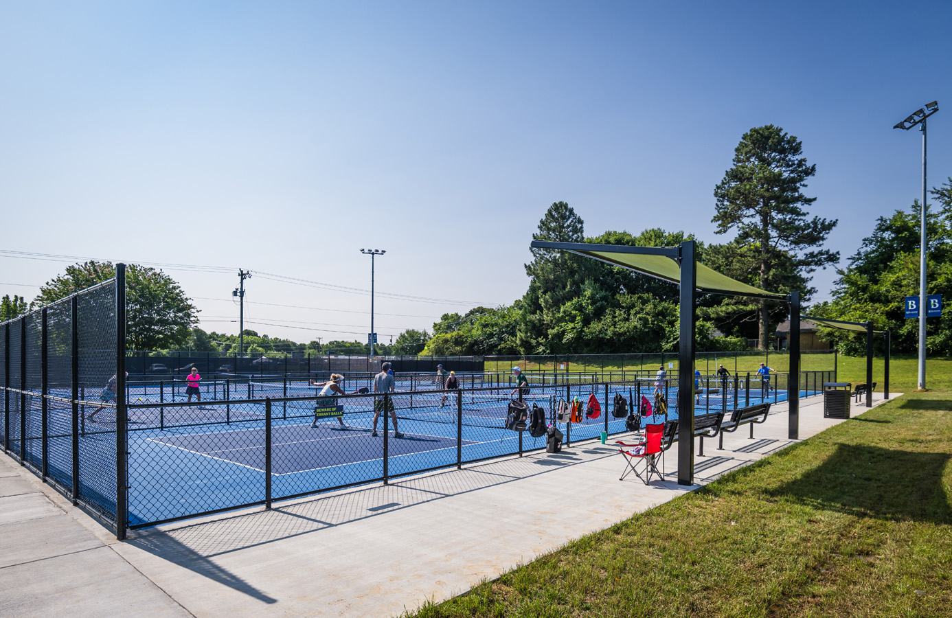 Players enjoying a pickleball match on blue courts at Fairchild Pickleball & Tennis in Burlington, North Carolina.