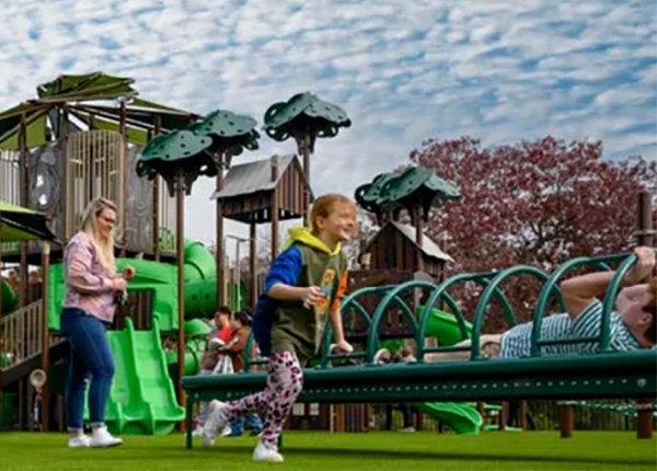 Children enjoying green nature-themed playground with slides and interactive play by Superior Recreation of the Carolinas.
