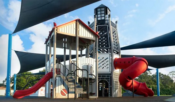 Superior Recreation of the Carolinas lighthouse-themed playground structure with red slides at a South Carolina community park.