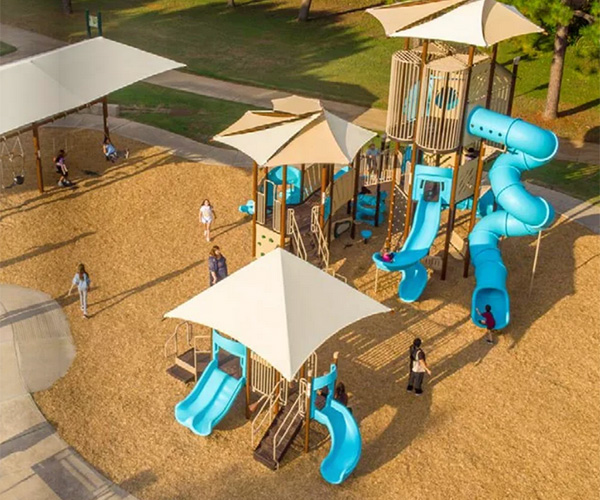 Superior Recreation of the Carolinas large playground with shade structures, slides, and towers in a North Carolina recreation park.