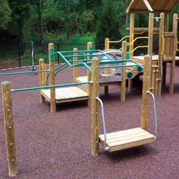 ADA-accessible playground structure with wood and green handrails, built on rubber mulch surfacing.