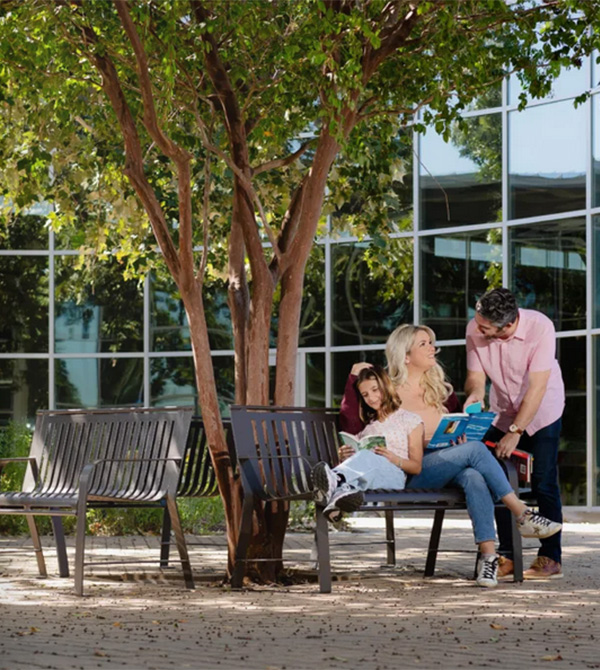 Park benches installed by Superior Recreation of the Carolinas providing shaded seating in a Carolina community space.